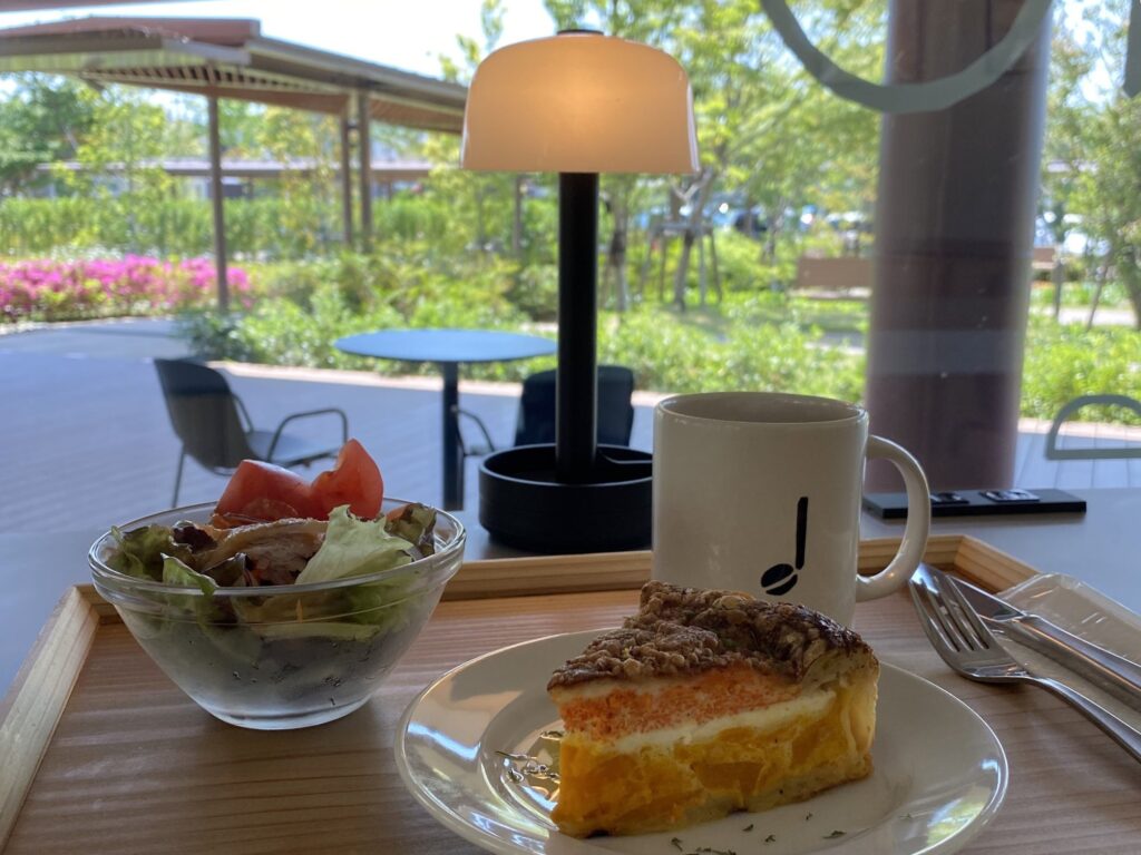 An example of the cafe menu: a large piece of quiche, a mini salad, and coffee